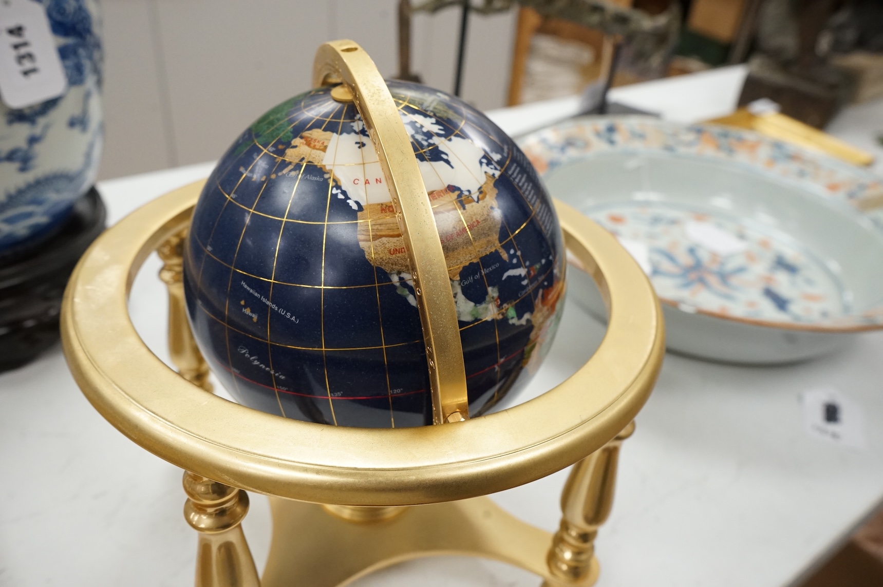 A table-top globe, on brass gimbal stand, 23cm in diameter
